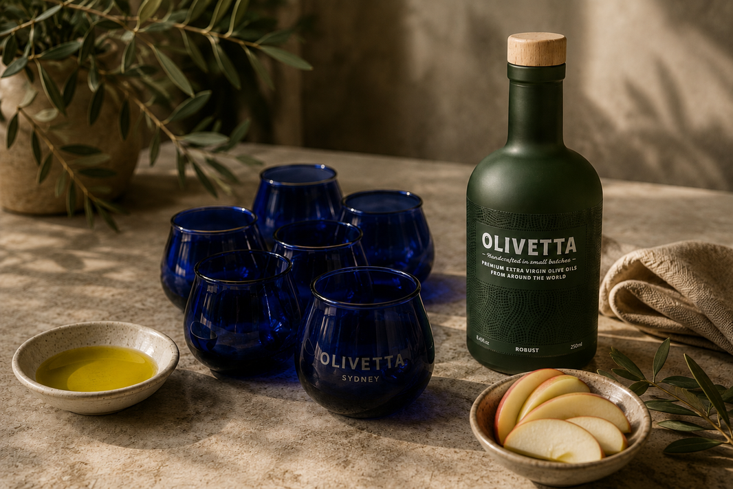Beyond the bottle olive oil tasting with blue glasses, robust EVOO and fresh apple slices.