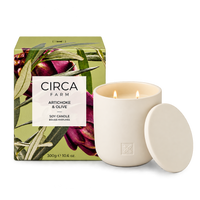 CIRCA Soy Candle Artichoke and Olive 300g in a cream ceramic vessel with lid beside artichoke print gift box