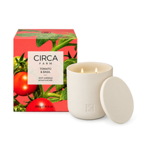 CIRCA Soy Candle Tomato and Basil 300g in a cream ceramic vessel with lid beside tomato vine print gift box