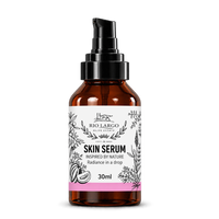 Rio Largo Olive Estate Skin Serum 30ml, an olive oil based facial serum for radiance and nourishment, presented in an amber glass bottle with a black pump dispenser.